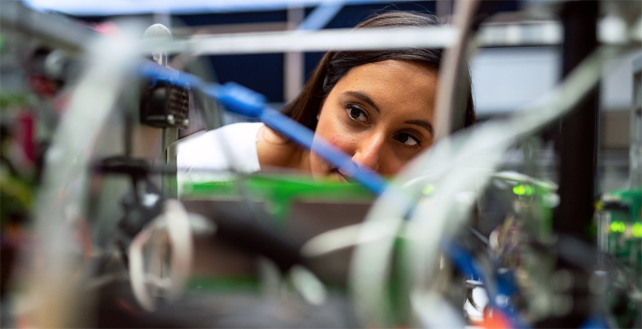 scientist looking through lab equipment