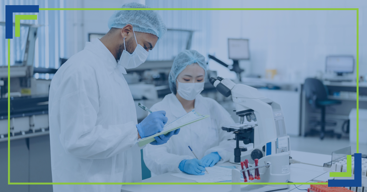 Male and female scientist looking through a microscope.